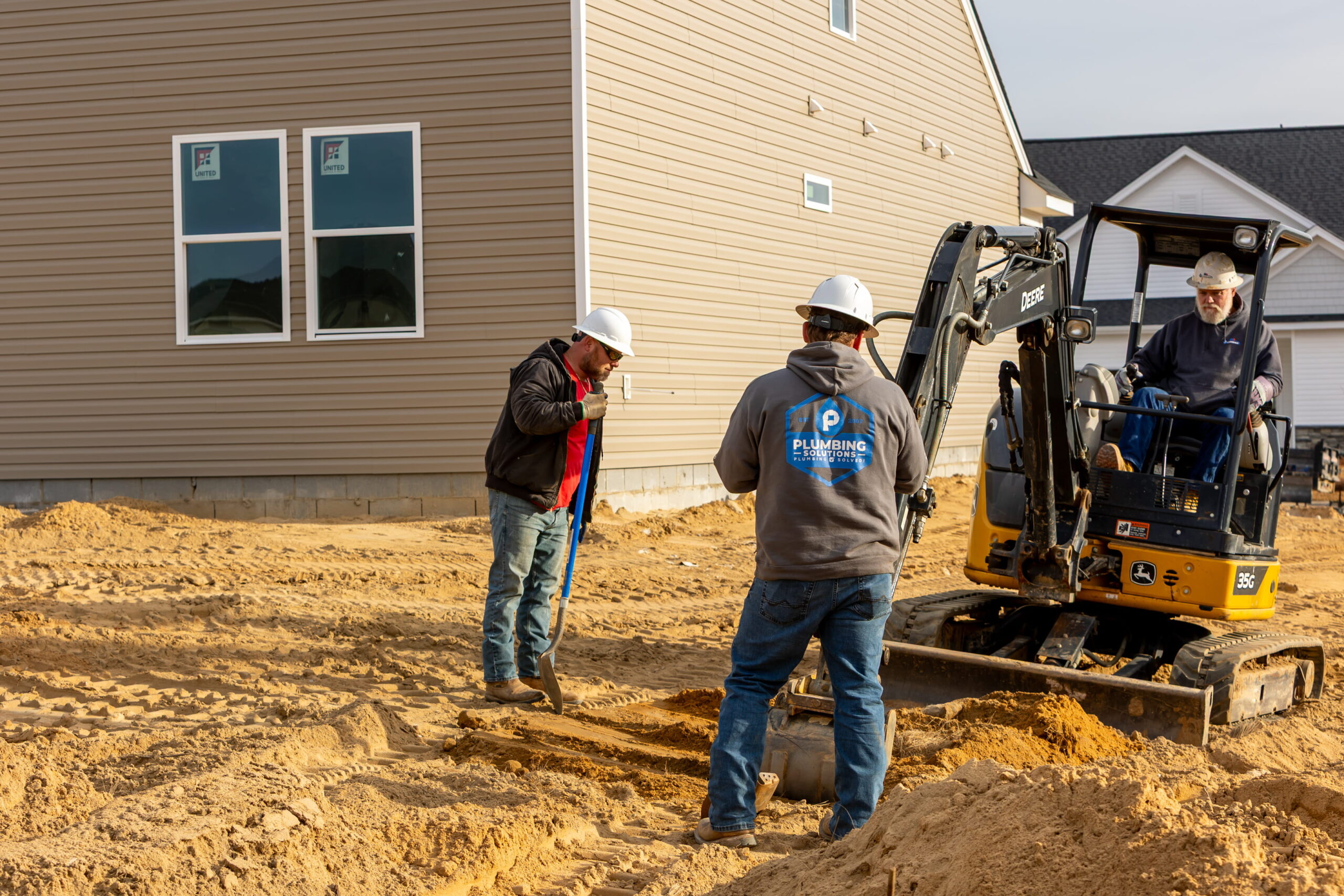 Plumbing Solutions LLC crew excavating for new home plumbing lines