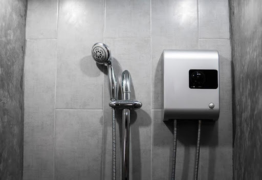 Plumbing Solutions LLC tankless water heater installed in a modern bathroom showing compact space saving design.