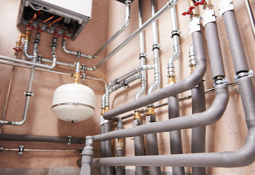 Plumbing Solutions LLC residential plumbing system with insulated pipes valves and connectors installed for water distribution.