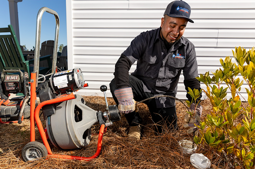 Plumbing Solutions LLC technician inspecting existing plumbing lines while evaluating a home for repiping services.
