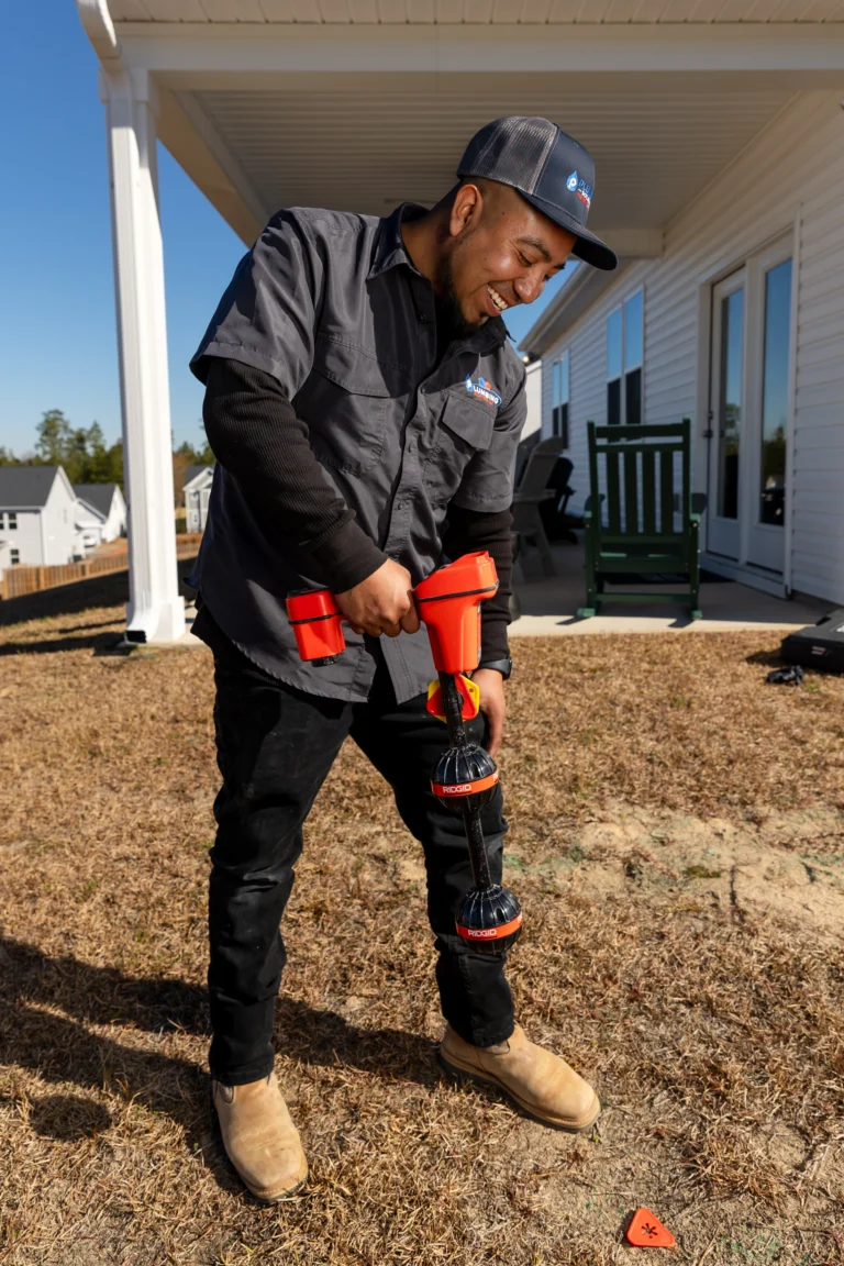 Plumber locating a hidden plumbing pipe to diagnose a potential leak or water system problem.